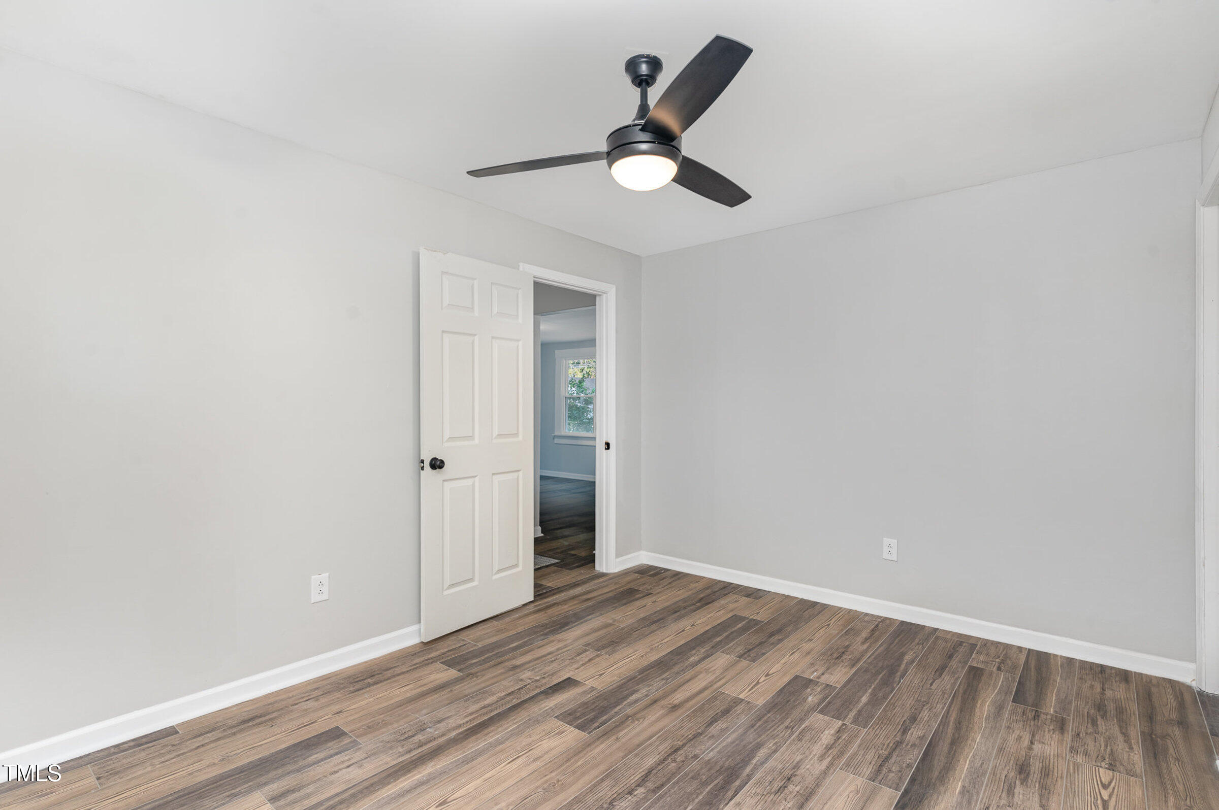 1323 Camden Road Fayetteville, NC 28306 - Photo 18 of 30 a view of a room with wooden floor and ceiling fan