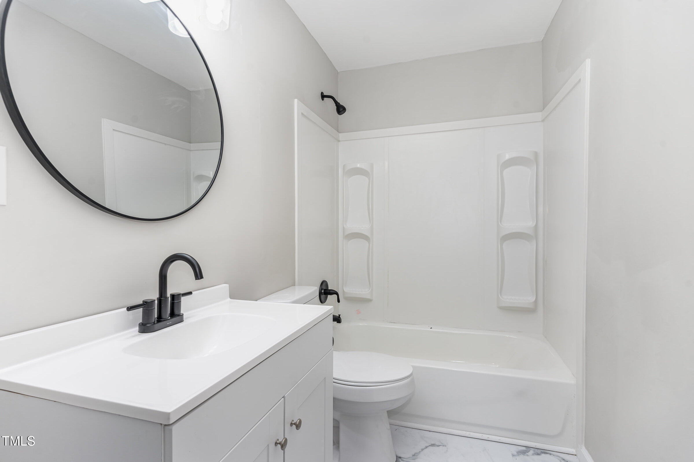 1323 Camden Road Fayetteville, NC 28306 - Photo 19 of 30 a bathroom with a sink a toilet and a mirror