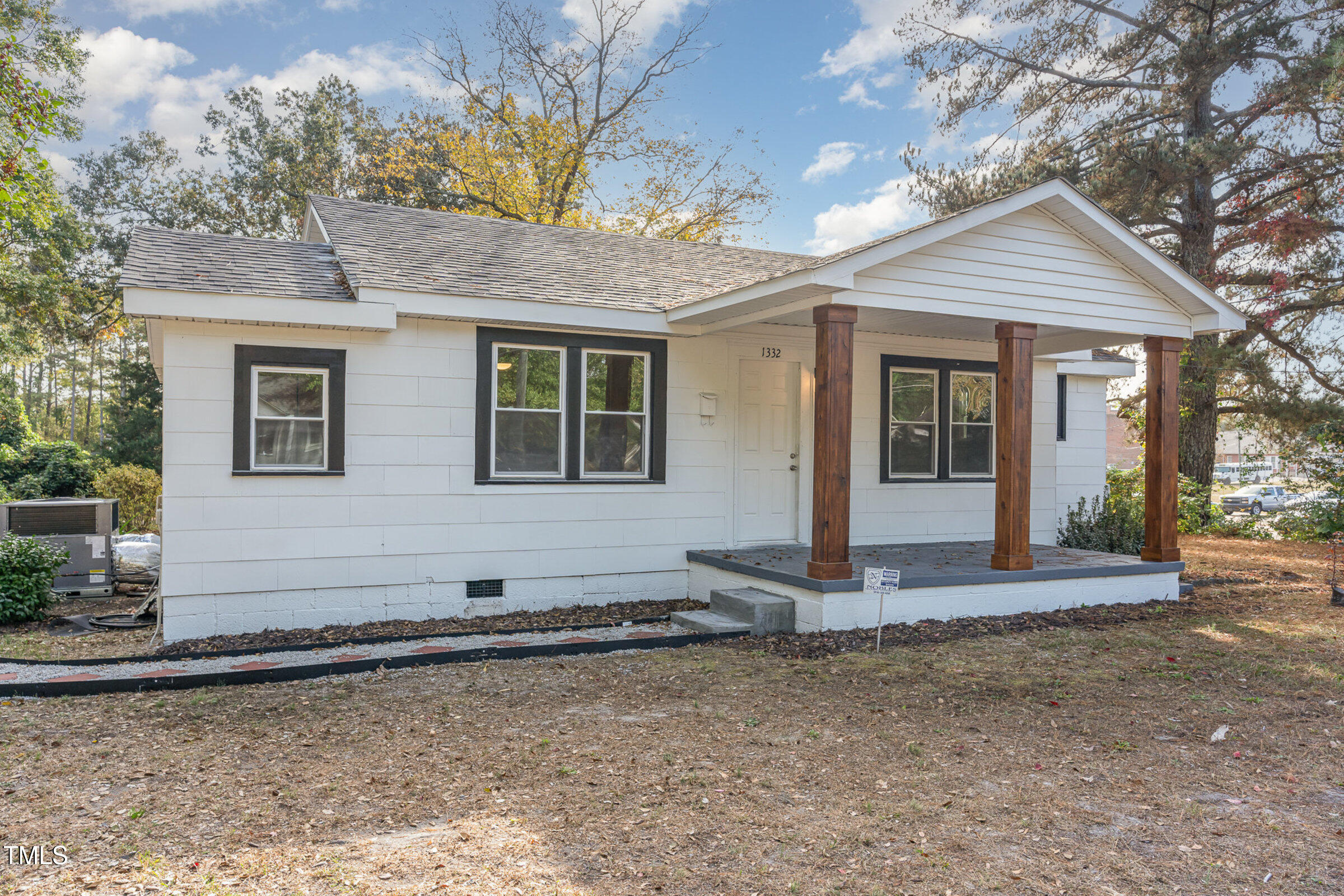 1323 Camden Road Fayetteville, NC 28306 - Photo 2 of 30 a front view of a house with a garden
