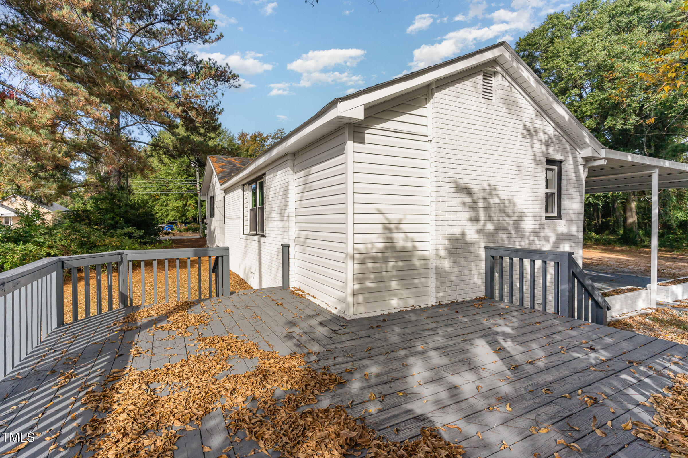 1323 Camden Road Fayetteville, NC 28306 - Photo 24 of 30 a view of a house with a wooden deck and a yard