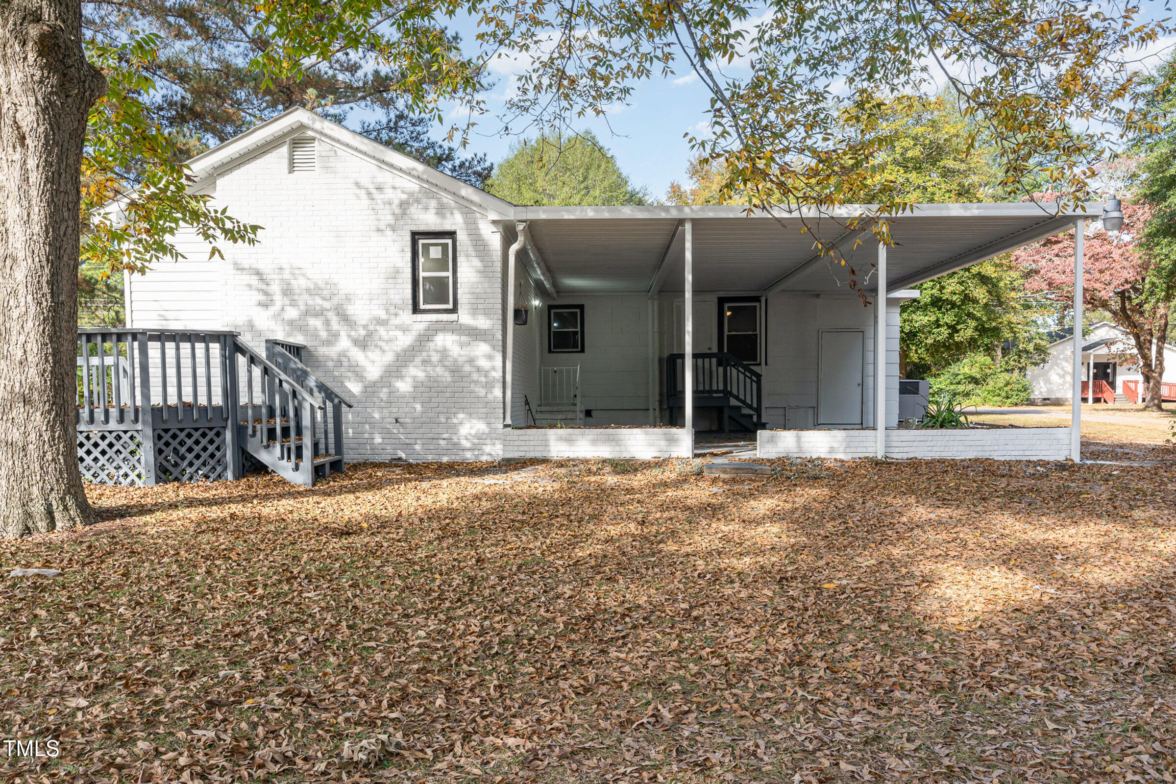 1323 Camden Road Fayetteville, NC 28306 - Photo 27 of 30 a view of a white house with a large tree and wooden fence
