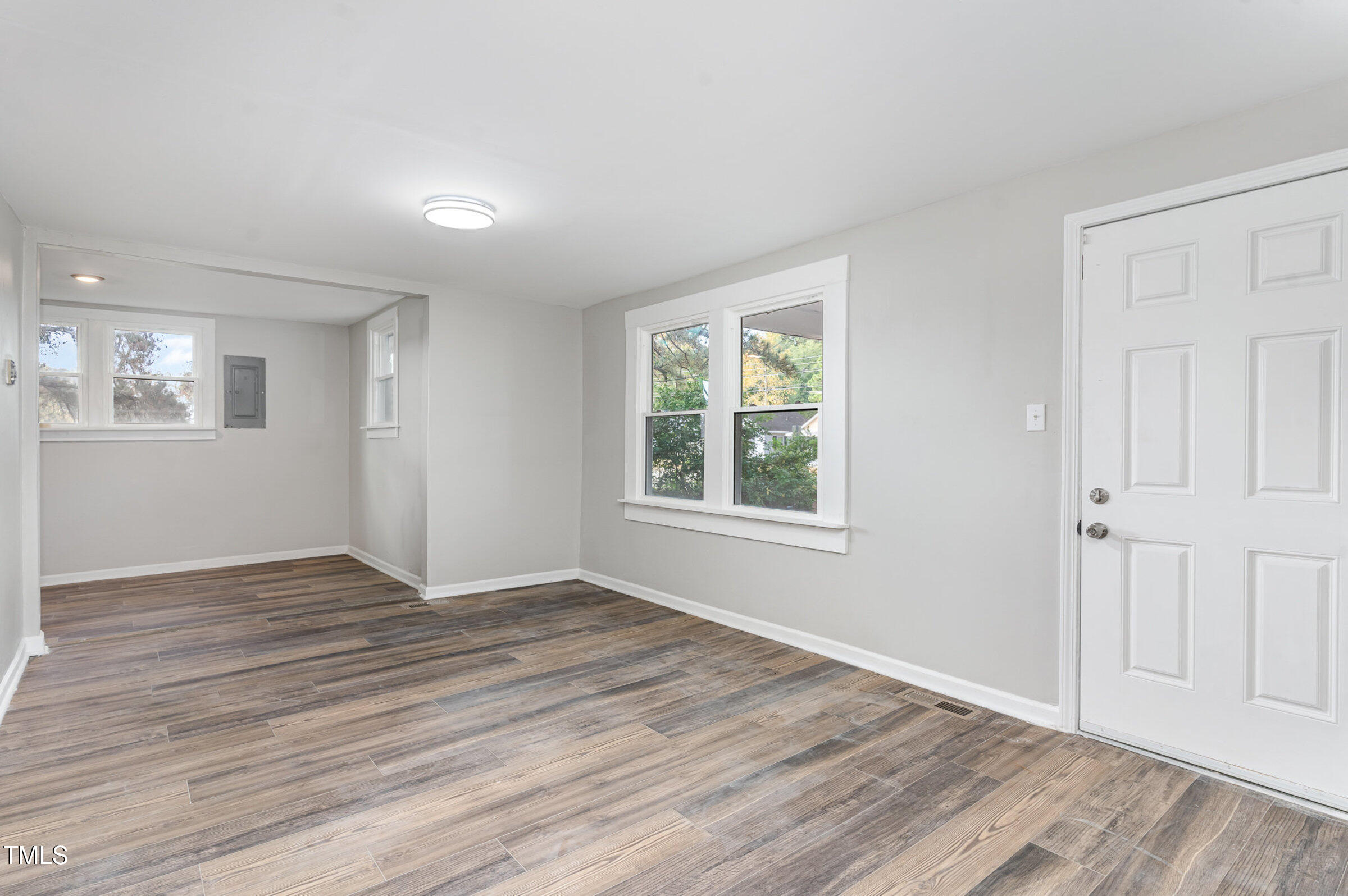 1323 Camden Road Fayetteville, NC 28306 - Photo 8 of 30 an empty room with wooden floor and windows