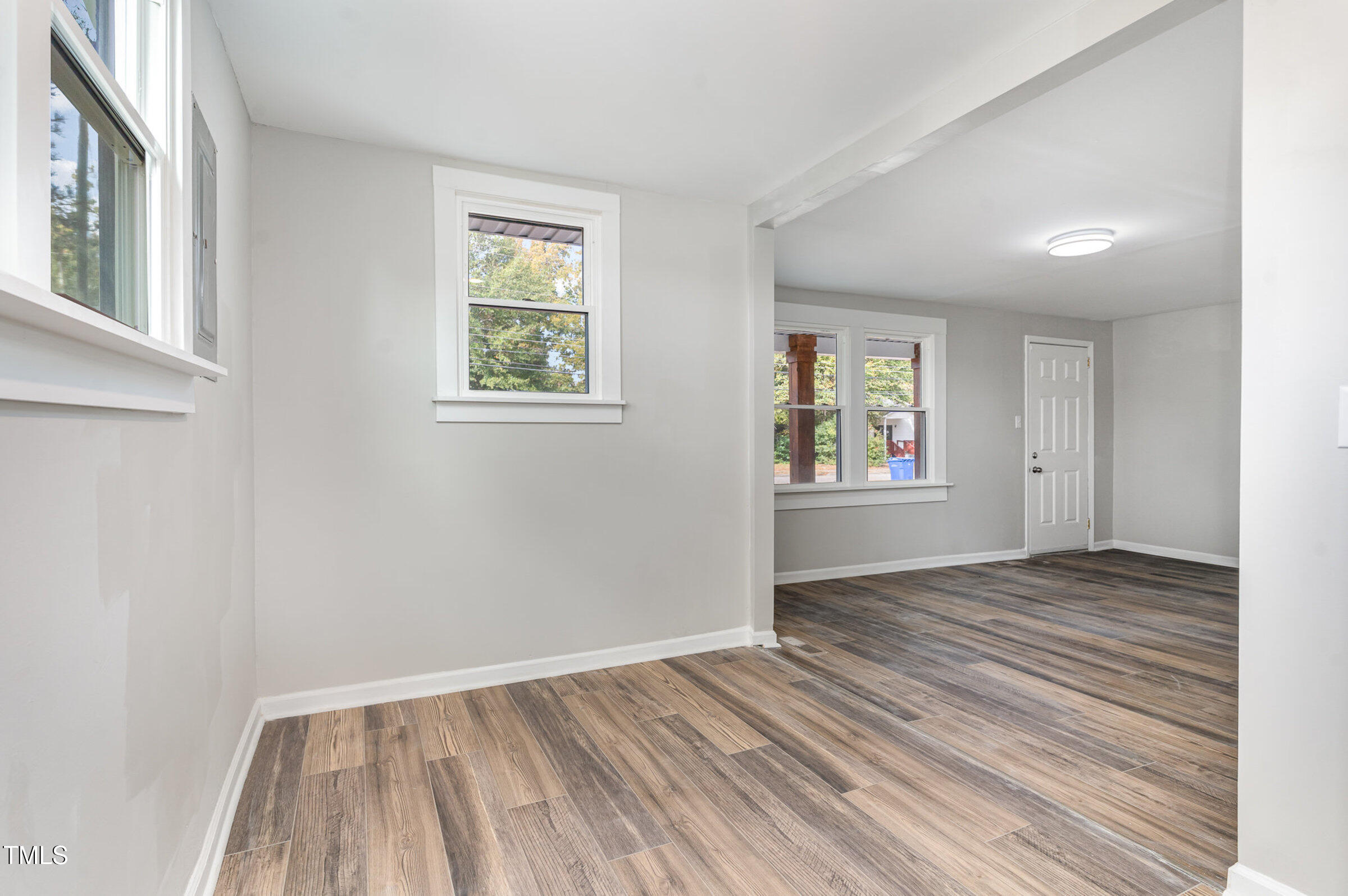 1323 Camden Road Fayetteville, NC 28306 - Photo 9 of 30 a view of an empty room with wooden floor and a window