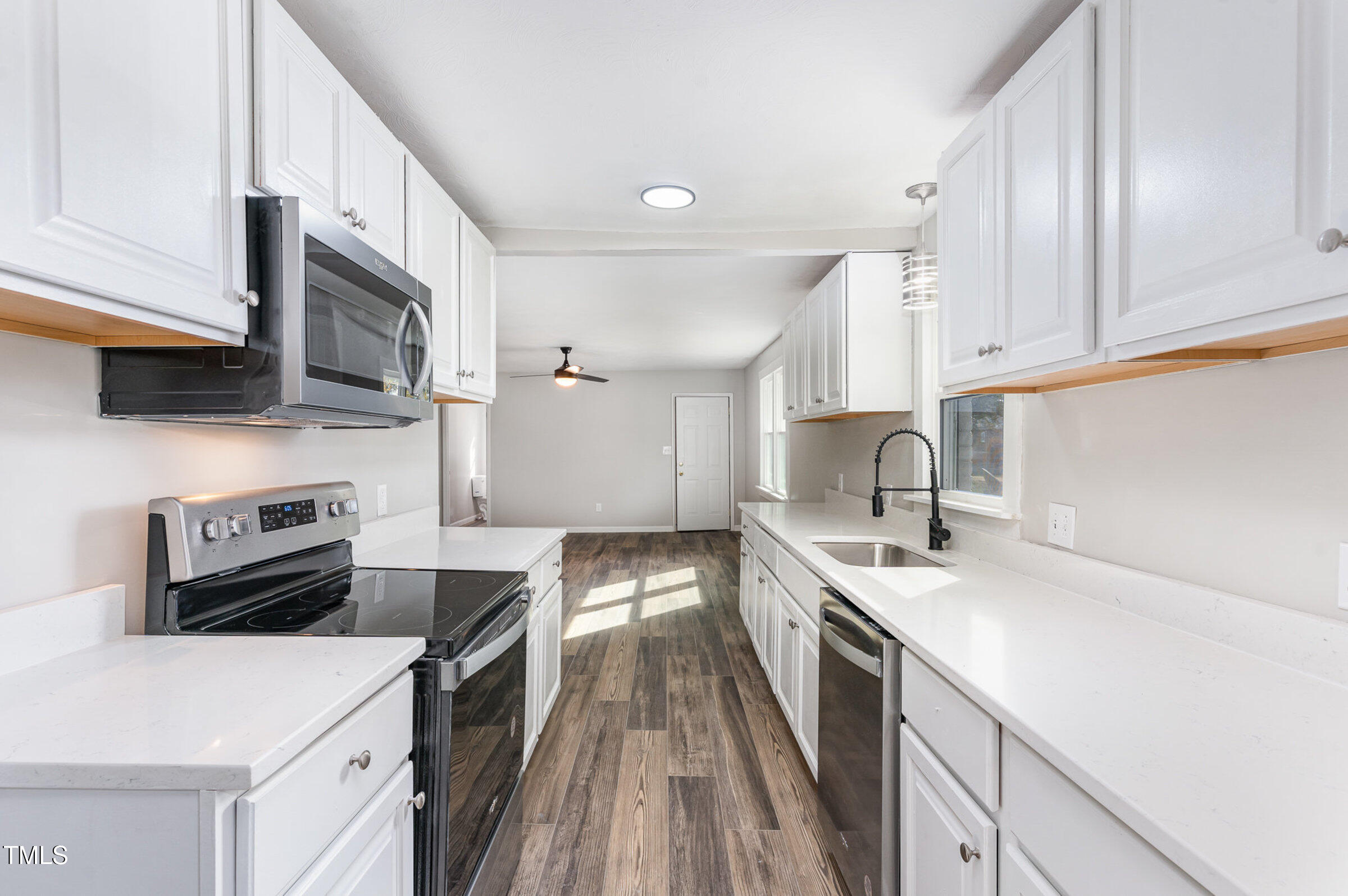 1323 Camden Road Fayetteville, NC 28306 - Photo 10 of 30 a kitchen with a sink stove top oven and cabinets