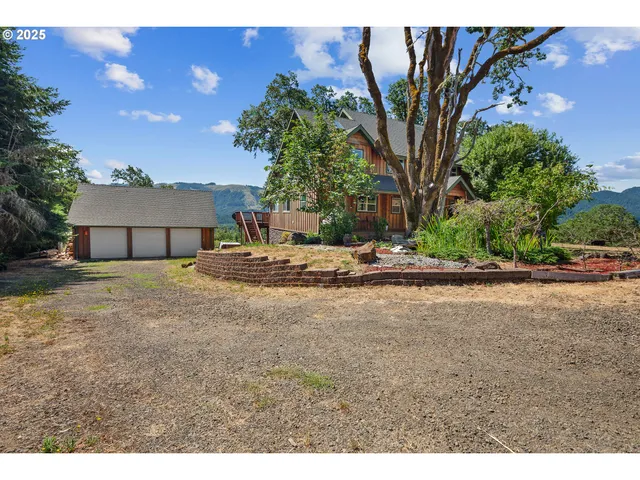 a view of a house with a yard and garage