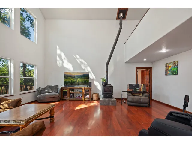 a kitchen with stainless steel appliances granite countertop a sink window and cabinets