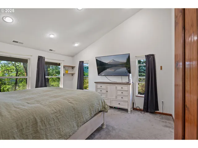 a bedroom with a large bed and a large window