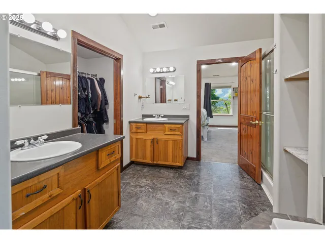 a bathroom with a sink a mirror and a shower