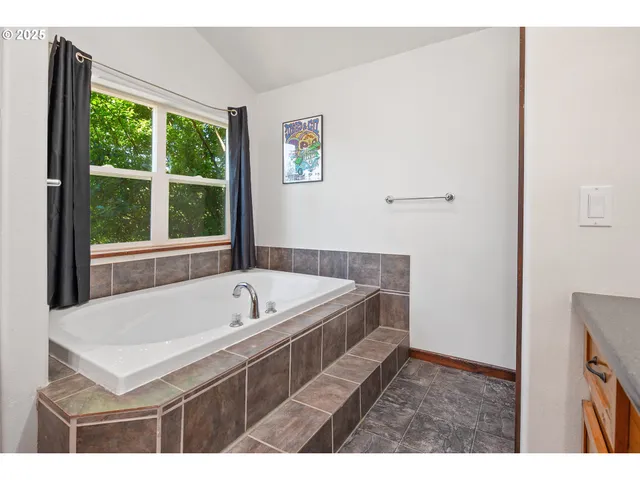 a spacious bedroom with a bed and window