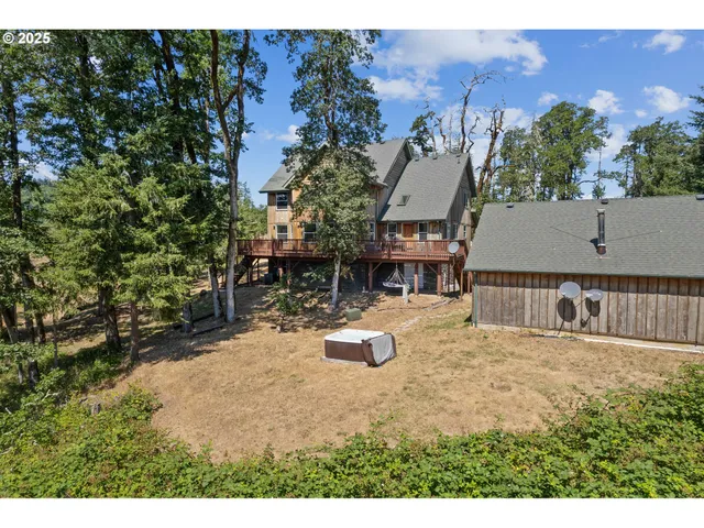 a view of a house with backyard and sitting area
