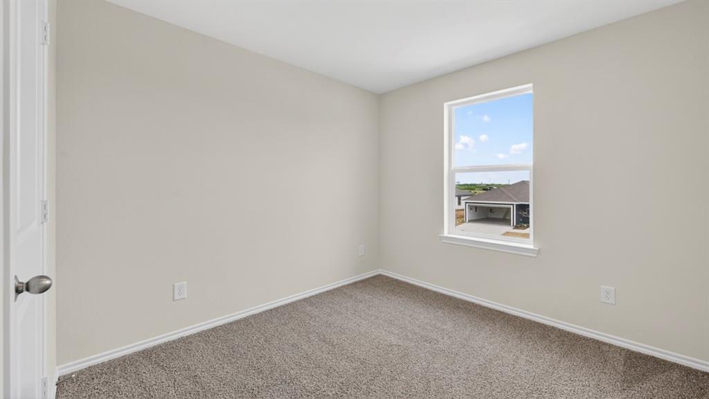 3534 Spring Time Street Forney, TX 75126 - Photo 16 of 24 Neutral-toned walls complement the gray carpeting