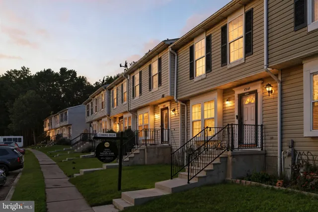 a view of a house with a yard and a garden
