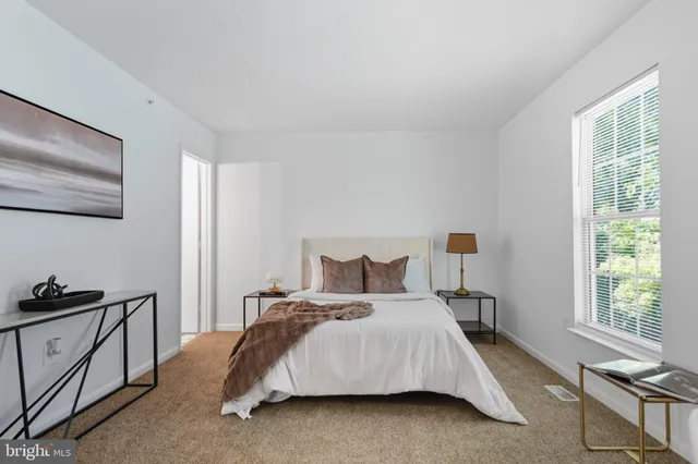 a bedroom with a bed and a window