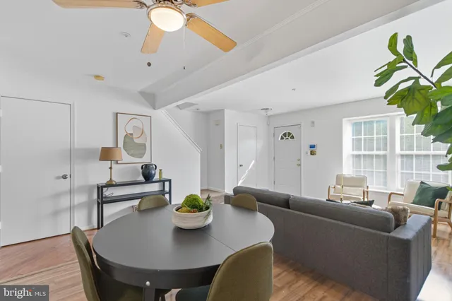 a living room with furniture and a dining table