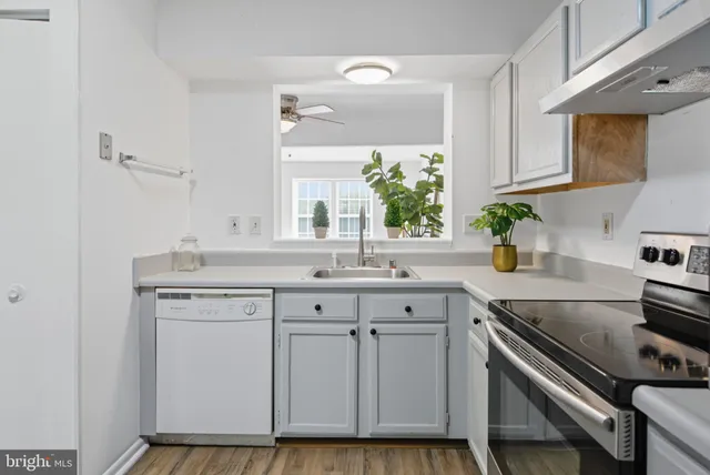 a kitchen with cabinets appliances and a sink