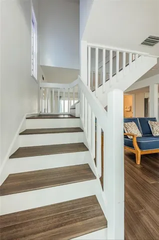 a bathroom with a granite countertop sink a toilet and shower