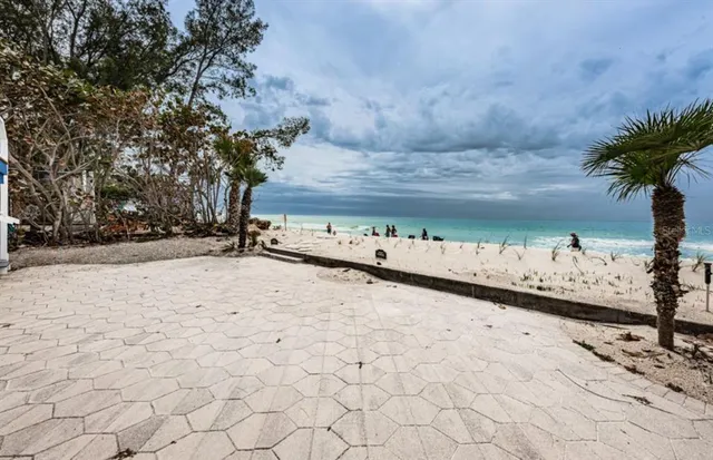 a dining hall with stainless steel appliances a dining table chairs and a refrigerator