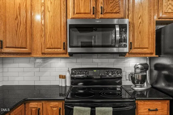 a kitchen with a stove and cabinets