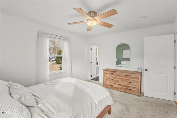 a bedroom with a bed and a dresser