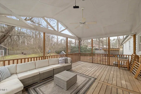 a balcony with furniture and a wooden floor