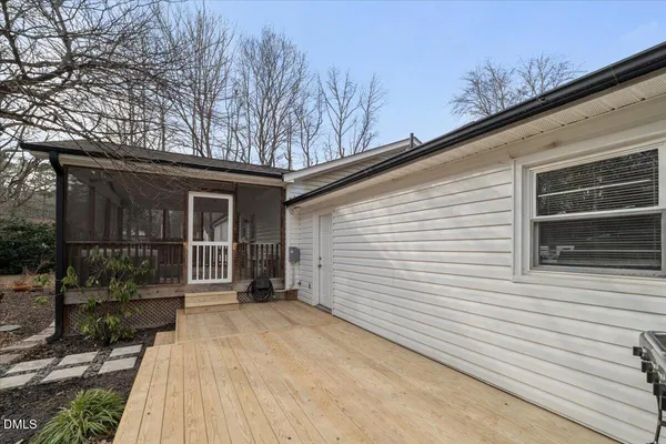 a view of a house with a yard and wooden fence