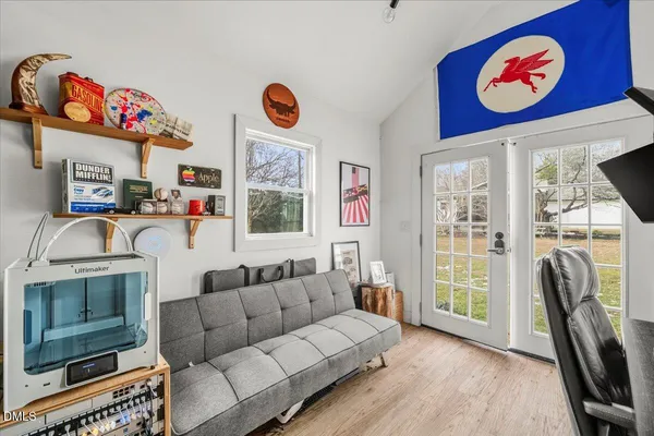 a living room with furniture a flat screen tv and a table