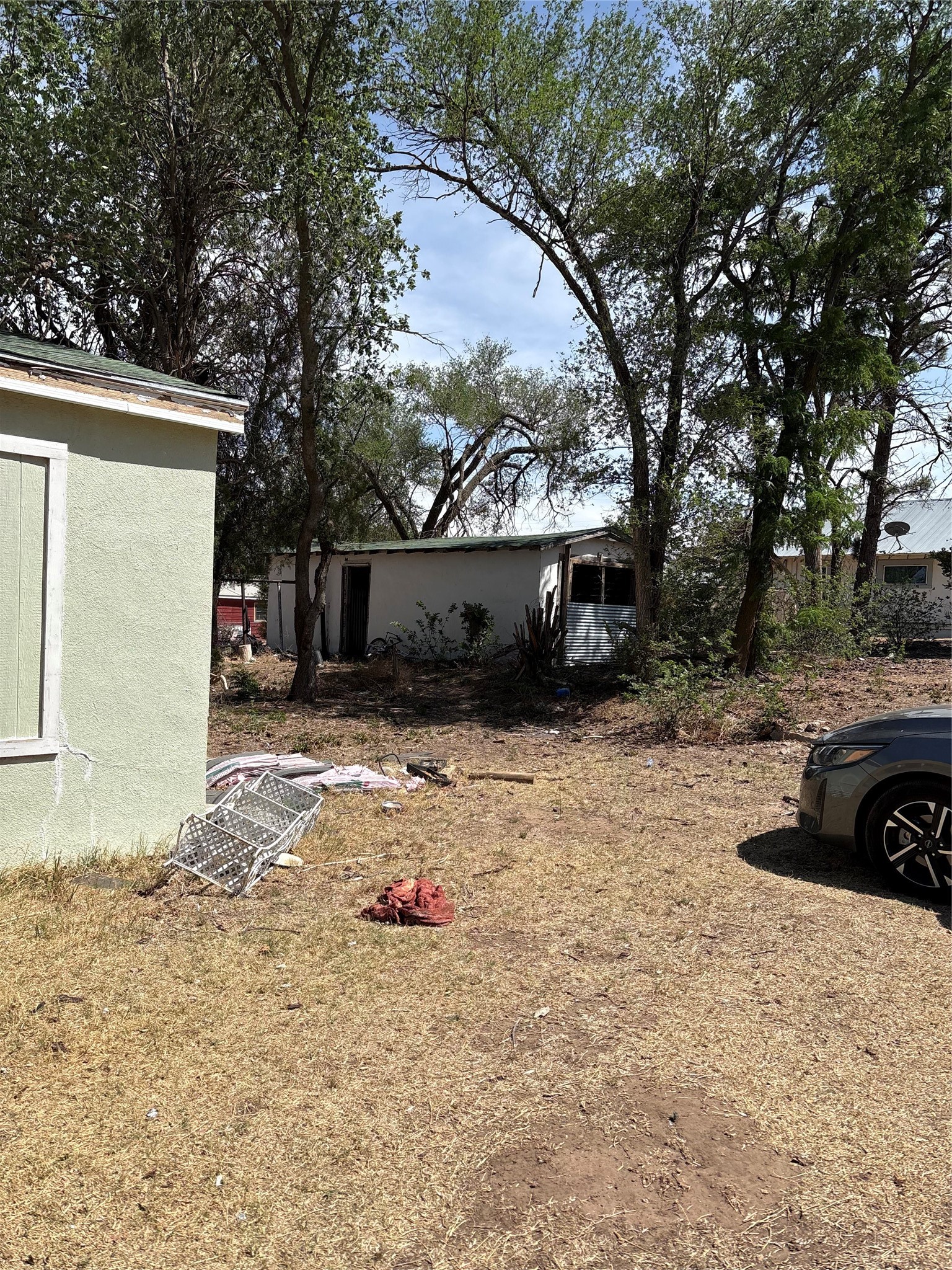 516 Walnut Street McLean, TX 79057 - Photo 4 of 16 a view of a yard with a car parked in front of house