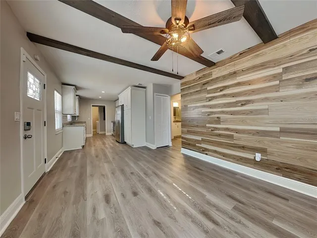 a view of a hallway with wooden floor