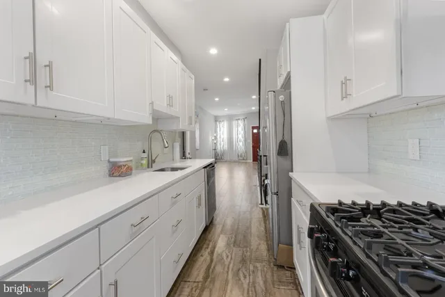 a kitchen with cabinets and a stove top oven