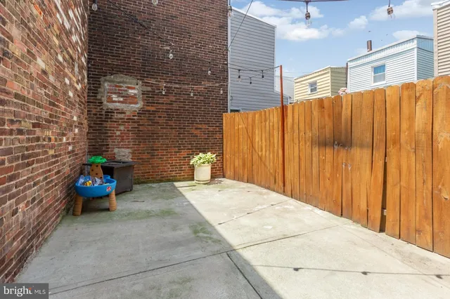 a view of a patio with couple of chairs and potted plants