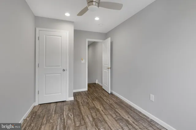 a view of hallway with a ceiling fan