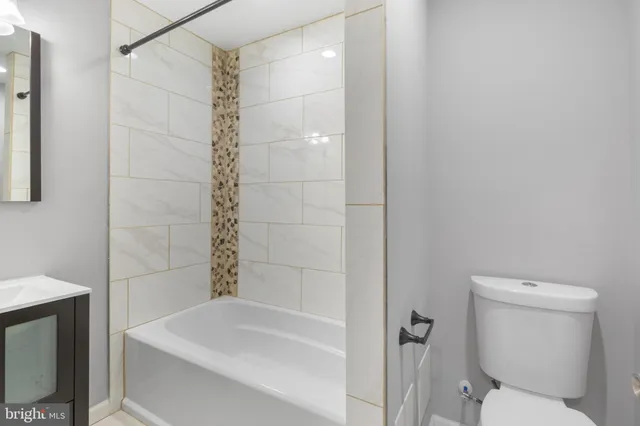 a bathroom with a bathtub and a toilet