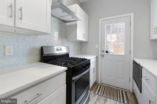 a kitchen with a stove and a white cabinet