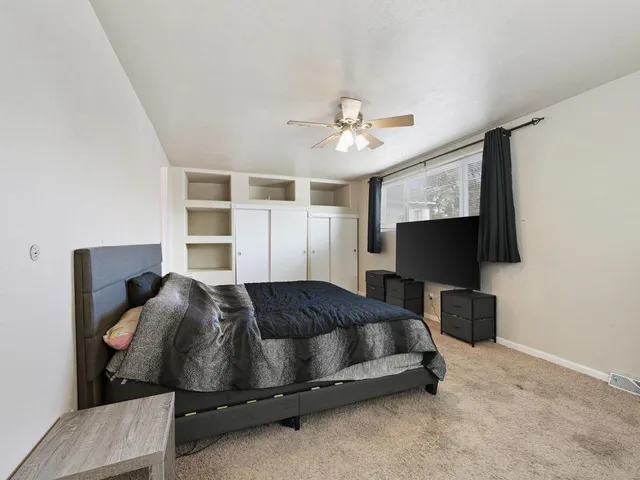 a bedroom with a bed closet and a window