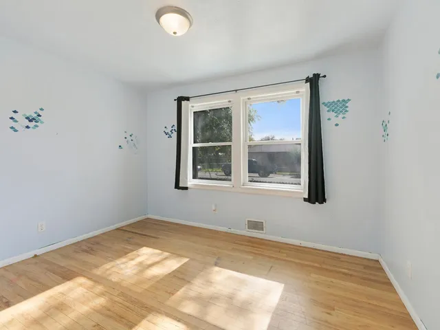 a view of a room with wooden floor and closet area