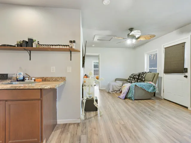 a view of a room with wooden floor and shelf