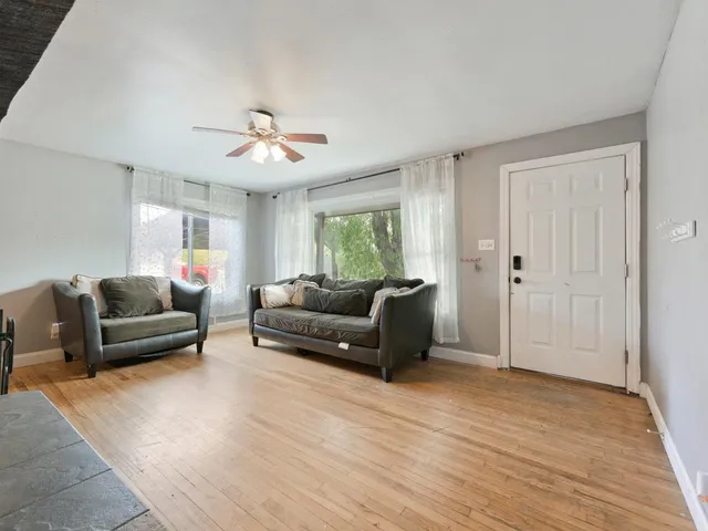 a living room with furniture and a wooden floor