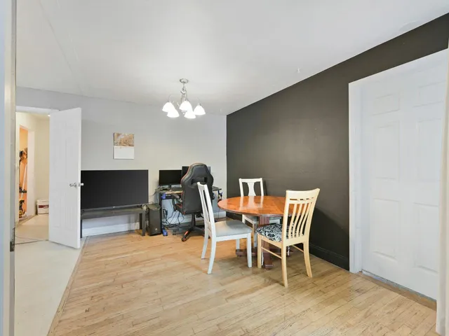 a dining room with furniture and wooden floor