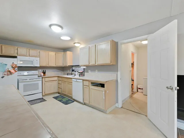 a kitchen that has a sink and a stove in it