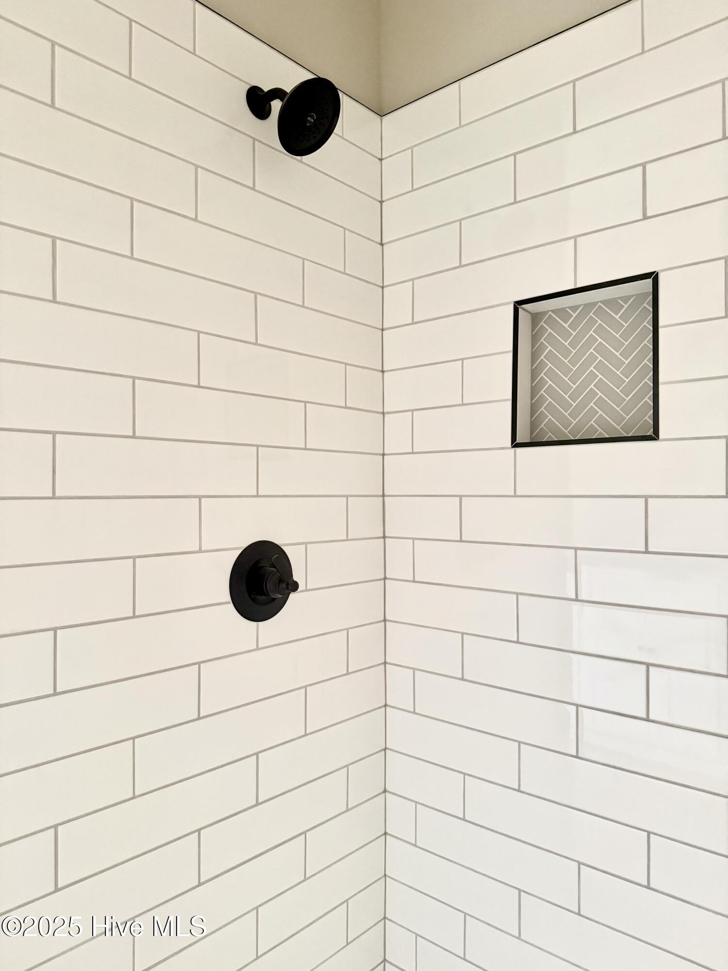 168 Clayton Road Princeton, NC 27569 - Photo 31 of 47 gorgeous large tiled primary shower with Black Faucets and built in niche' for shampoo and conditioner storage.