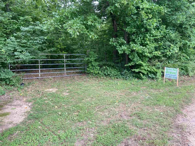 a view of a yard with wooden fence