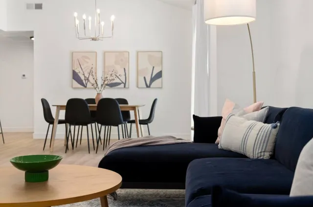 a living room with furniture and a chandelier
