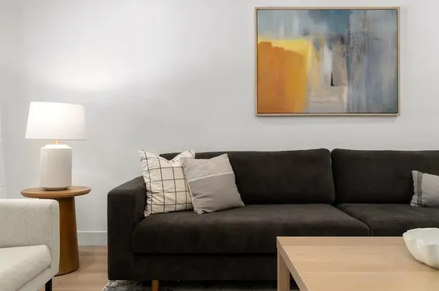 a living room with a couch and a lamp