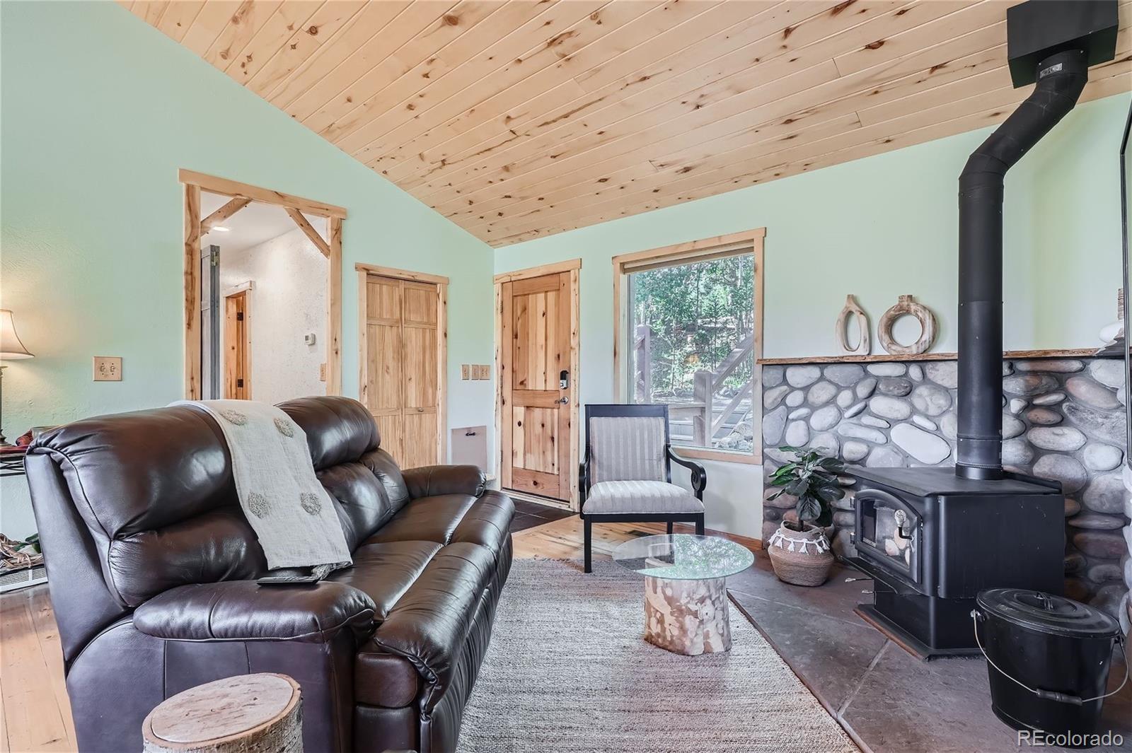 51 High View Lane Bailey, CO 80421 - Photo 8 of 38 a living room with furniture and a fireplace