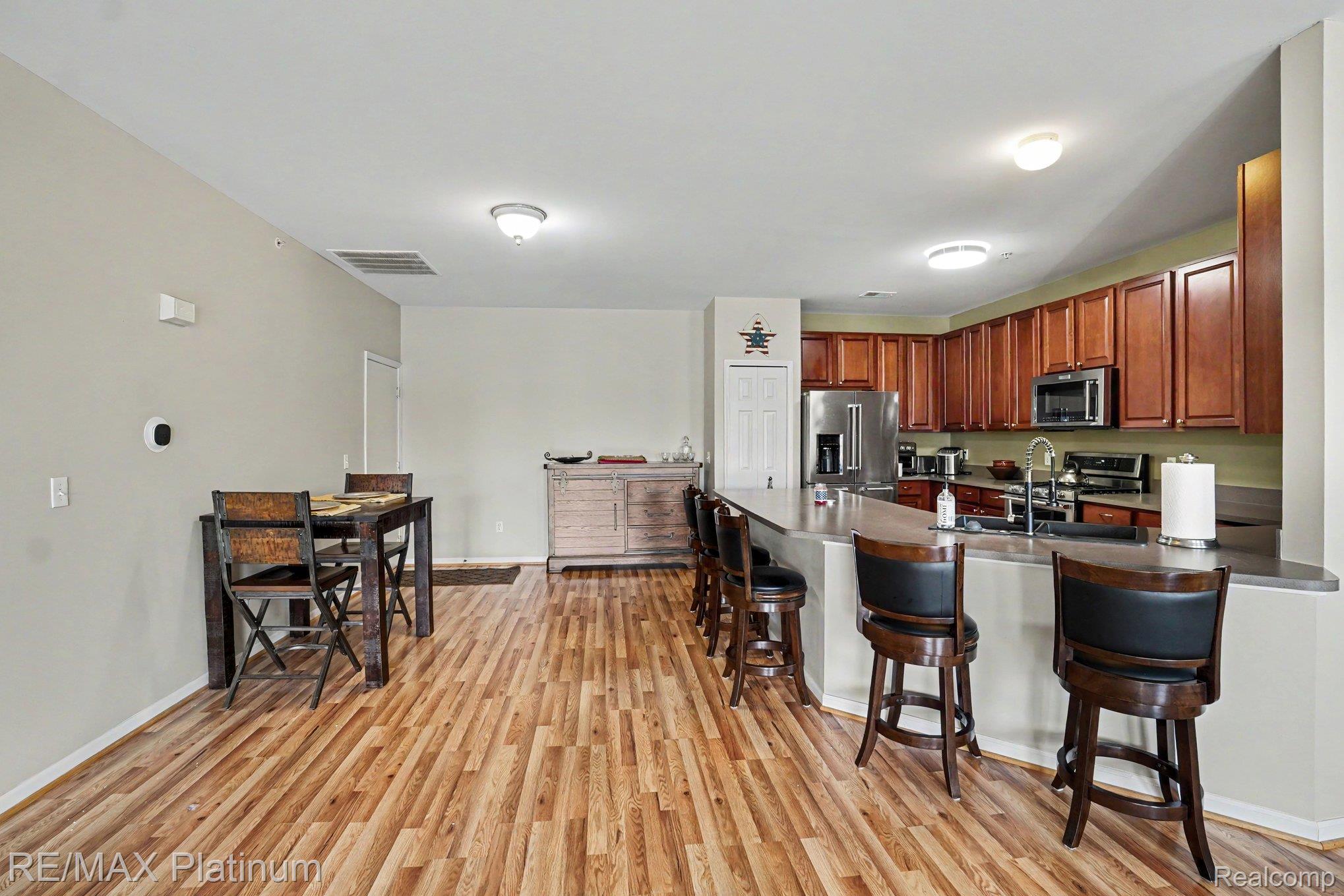10217 Crossview Trail Howell, MI 48855 - Photo 10 of 26 Open-concept kitchen and dining area with wood-finish flooring