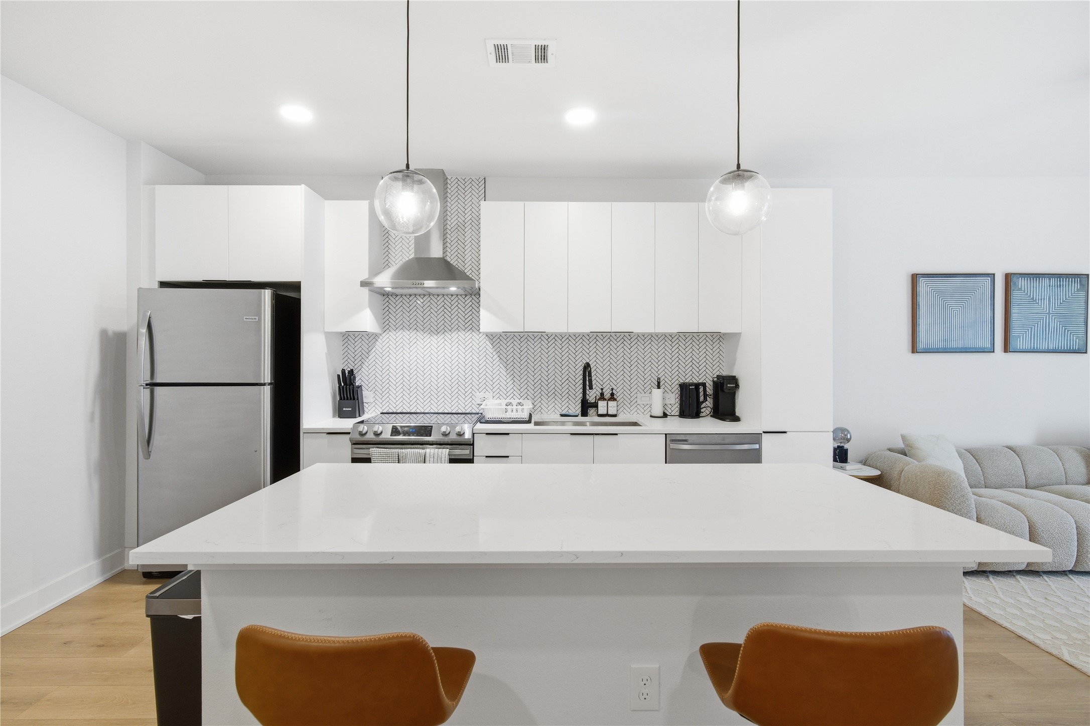 2500 Longview Street, Unit 219 Austin, TX 78705 - Photo 2 of 40 a kitchen with stainless steel appliances granite countertop a sink a stove a refrigerator and island with wooden floor