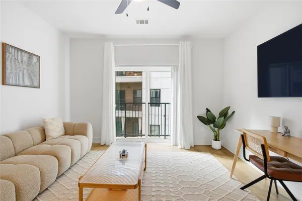 a living room with furniture and a potted plant