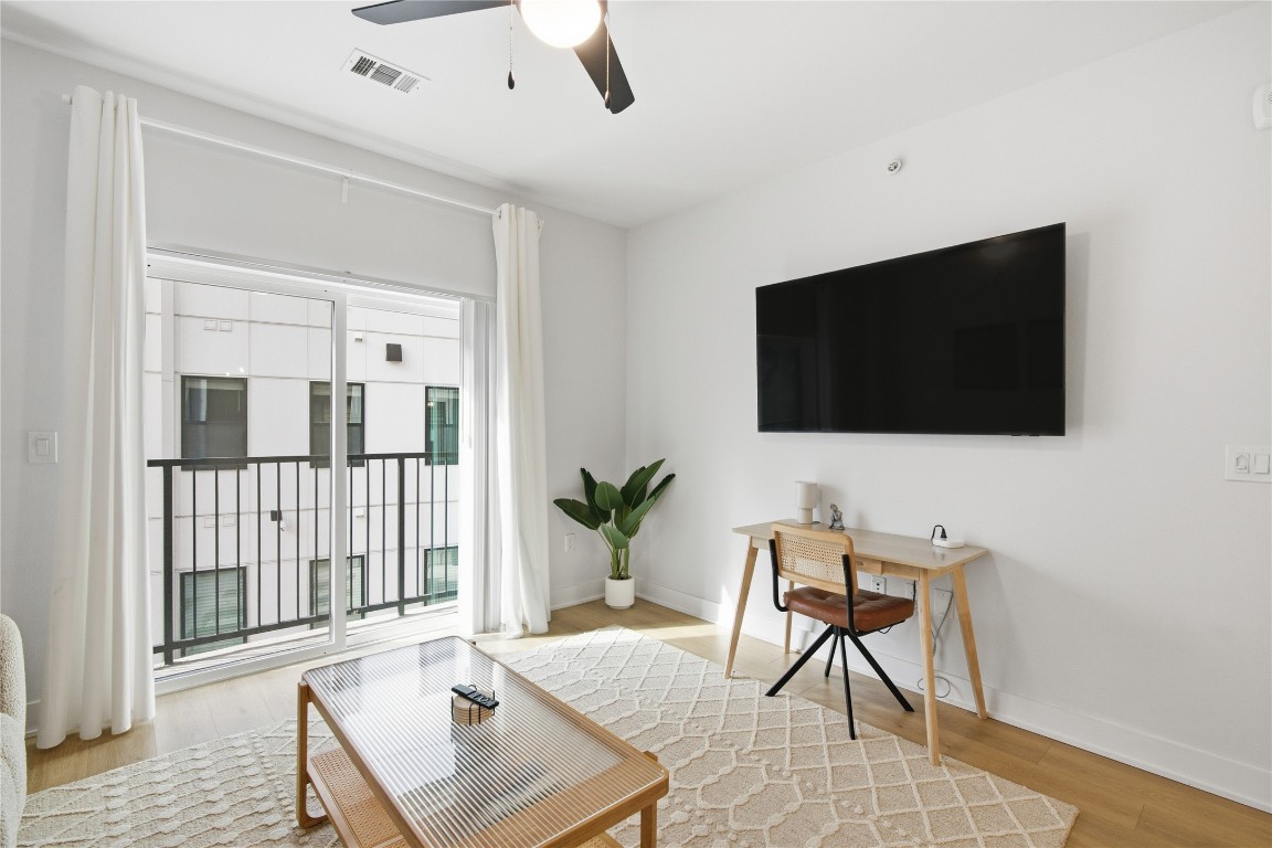 2500 Longview Street, Unit 219 Austin, TX 78705 - Photo 5 of 40 a living room with furniture and a flat screen tv