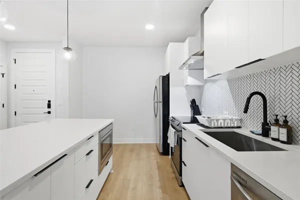 a view of a kitchen counter space a sink and dishwasher