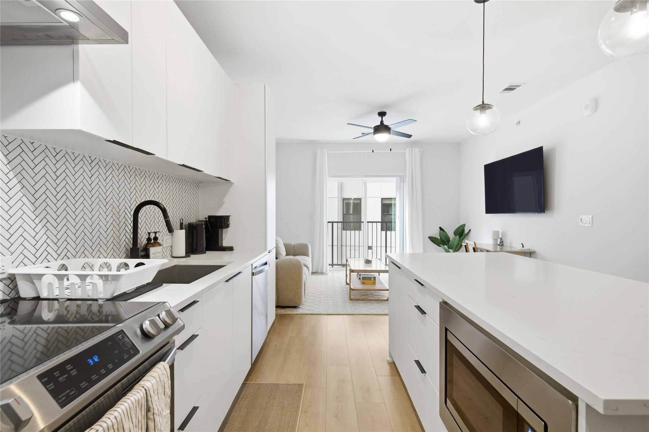 2500 Longview Street, Unit 219 Austin, TX 78705 - Photo 39 of 40 a large kitchen with a large counter top a sink stainless steel appliances and cabinets